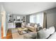 Bright living room features a fireplace, built-in shelving, hardwood floors, and large windows at 5840 Brouse Ave, Indianapolis, IN 46220