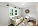 Inviting living space with a loveseat, chair, and modern accents at 5840 Brouse Ave, Indianapolis, IN 46220