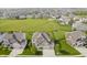 Aerial view of homes in neighborhood, complete with green space, pools, and playground at 6101 Hardwick Dr, Whitestown, IN 46075