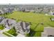 Aerial view showcasing the vast neighborhood with green space, and a water tower in the distance at 6101 Hardwick Dr, Whitestown, IN 46075