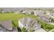 Wide aerial shot of multiple houses in neighborhood with large green space, pools, and playgrounds at 6101 Hardwick Dr, Whitestown, IN 46075