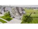Aerial view of two-story home featuring well-manicured lawn and three-car garage at 6101 Hardwick Dr, Whitestown, IN 46075