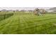 A sprawling fenced backyard offers a playset and plenty of space for outdoor activities at 6101 Hardwick Dr, Whitestown, IN 46075