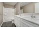 A modern bathroom features double vanity, shower over tub, and gray wood flooring at 6101 Hardwick Dr, Whitestown, IN 46075