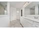 Bright bathroom features a glass-enclosed shower, tile flooring, a large mirror and double sinks at 6101 Hardwick Dr, Whitestown, IN 46075