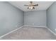 Empty bedroom with neutral colored carpet, light gray walls, and a ceiling fan at 6101 Hardwick Dr, Whitestown, IN 46075