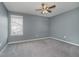 Empty bedroom with neutral colored carpet, light gray walls, and a ceiling fan at 6101 Hardwick Dr, Whitestown, IN 46075