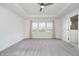 Spacious bedroom features carpet, a ceiling fan, and large windows with neighborhood views at 6101 Hardwick Dr, Whitestown, IN 46075