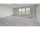 Bright bedroom features neutral walls, carpet, and large windows offering views of the community at 6101 Hardwick Dr, Whitestown, IN 46075