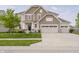 Beautiful two-story home with a well-manicured lawn and a three car garage at 6101 Hardwick Dr, Whitestown, IN 46075