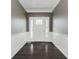 Inviting foyer featuring dark hardwood floors, decorative molding and neutral wall paint at 6101 Hardwick Dr, Whitestown, IN 46075