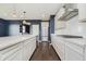 Gourmet kitchen with stainless appliances, island, ample cabinetry, and stylish pendant lighting at 6101 Hardwick Dr, Whitestown, IN 46075