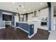 Spacious kitchen boasts a large center island, elegant pendant lights, and stainless steel appliances at 6101 Hardwick Dr, Whitestown, IN 46075