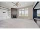 Open living room with fireplace, custom built-ins, ceiling fan and lots of light at 6101 Hardwick Dr, Whitestown, IN 46075