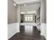 Entryway to living room with wall paneling, carpet and a view of fireplace and staircase at 6101 Hardwick Dr, Whitestown, IN 46075