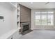 Cozy living room features fireplace, custom built-ins, and large windows with a backyard view at 6101 Hardwick Dr, Whitestown, IN 46075
