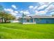 Expansive backyard featuring a well-maintained lawn and inviting decks on the blue home at 618 N Buckingham Ct, Anderson, IN 46013