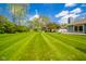 Sprawling backyard with manicured lawn and mature trees, offering a serene outdoor space at 618 N Buckingham Ct, Anderson, IN 46013
