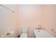 Simple bathroom featuring a toilet, a vintage-style bathtub, and a towel rack against a clean and minimalist backdrop at 618 N Buckingham Ct, Anderson, IN 46013
