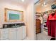 Chic bathroom with a granite countertop, a white vanity, and a walk-in closet, offering style and functionality at 618 N Buckingham Ct, Anderson, IN 46013