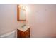 Compact bathroom featuring a vanity with a wooden cabinet, a white sink, a medicine cabinet, and basic fixtures at 618 N Buckingham Ct, Anderson, IN 46013