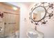 This bathroom boasts a modern sink, decorative mirror, and walk-in shower at 618 N Buckingham Ct, Anderson, IN 46013