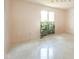Spacious bedroom featuring sleek tile flooring and a window overlooking lush greenery at 618 N Buckingham Ct, Anderson, IN 46013