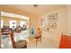 A sunlit dining area featuring a glass table, designer chairs, and an open layout with neutral walls and tile flooring at 618 N Buckingham Ct, Anderson, IN 46013