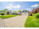 Inviting home with a well-maintained lawn, a brick garage, and a blue-paneled facade at 618 N Buckingham Ct, Anderson, IN 46013