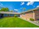 Well-kept exterior with a lush green lawn and a combination of brick and siding at 618 N Buckingham Ct, Anderson, IN 46013