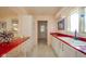 Bright eat-in kitchen featuring white cabinets, a red countertop island and matching countertops at 618 N Buckingham Ct, Anderson, IN 46013