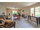 Bright living room featuring marble floors, a fireplace, and unique wicker furnishings for relaxed comfort at 618 N Buckingham Ct, Anderson, IN 46013
