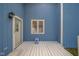Charming blue-paneled patio with a white door and window, perfect for relaxing outdoors at 618 N Buckingham Ct, Anderson, IN 46013