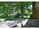 Backyard with mature trees and lush greenery creating a peaceful outdoor space, with a built-in fire pit at 6334 Teak Ct, Indianapolis, IN 46217