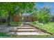 Backyard featuring a brick and siding exterior, multi-level patio, and mature trees providing a serene atmosphere at 6334 Teak Ct, Indianapolis, IN 46217