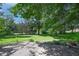 Secluded backyard featuring mature trees and lush greenery providing shade and privacy, with a patio area at 6334 Teak Ct, Indianapolis, IN 46217