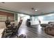 Finished basement area with gray flooring, green accent wall, and comfortable seating at 6334 Teak Ct, Indianapolis, IN 46217