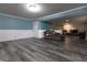 Spacious basement featuring gray flooring, aqua accent wall, and a comfortable seating area at 6334 Teak Ct, Indianapolis, IN 46217