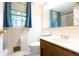 Well-lit bathroom with a wood vanity and toilet at 6334 Teak Ct, Indianapolis, IN 46217