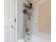 Bathtub and shower featuring tiled walls and shower caddy at 6334 Teak Ct, Indianapolis, IN 46217