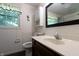 This bathroom features white paneled walls, a dark wood vanity, and a white sink at 6334 Teak Ct, Indianapolis, IN 46217