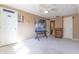 Carpeted bedroom featuring a ceiling fan, white door, and tan walls at 6334 Teak Ct, Indianapolis, IN 46217
