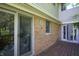 Exterior showcasing sliding glass doors leading to a wooden deck, complemented by brick and siding finishes at 6334 Teak Ct, Indianapolis, IN 46217