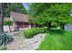 Lovely home featuring mature trees, manicured shrubbery, and charming red shutters at 6334 Teak Ct, Indianapolis, IN 46217