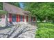 Exterior shot of a home with red shutters and landscaping, enhanced by a stone walkway at 6334 Teak Ct, Indianapolis, IN 46217