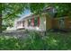 The exterior of this house features neutral siding, red shutters, and a front yard with a brick walkway at 6334 Teak Ct, Indianapolis, IN 46217