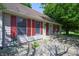 Home exterior with stone walkway and red shutters, with landscaping around the front of the house at 6334 Teak Ct, Indianapolis, IN 46217
