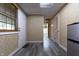 Hallway featuring gray flooring, access to a mini fridge, and paneled doors at 6334 Teak Ct, Indianapolis, IN 46217