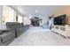 Bright living room with marble floors, fireplace, and a large screen television for entertainment at 6334 Teak Ct, Indianapolis, IN 46217