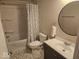 This bathroom features a tub with shower, vanity, toilet, and rounded mirror at 706 Alexander St, Greenwood, IN 46143